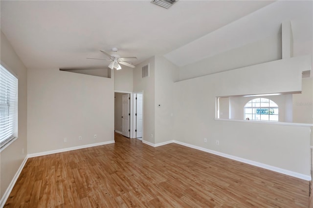 unfurnished room featuring ceiling fan, lofted ceiling, and light hardwood / wood-style flooring