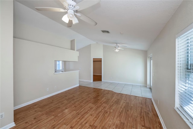 unfurnished living room with ceiling fan, light hardwood / wood-style floors, and lofted ceiling