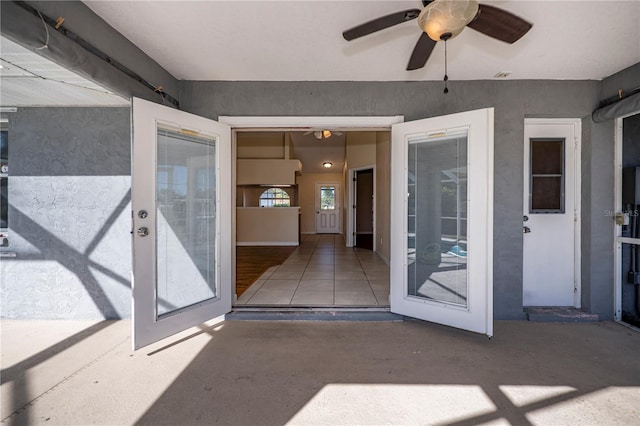 property entrance featuring a patio and ceiling fan