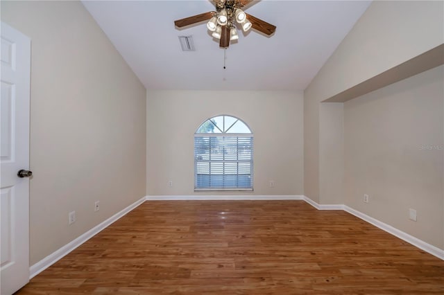 empty room with lofted ceiling, ceiling fan, and wood-type flooring