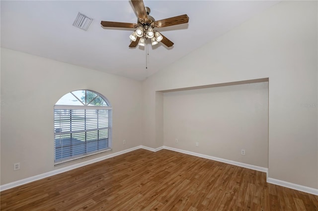 empty room featuring hardwood / wood-style flooring, ceiling fan, and lofted ceiling