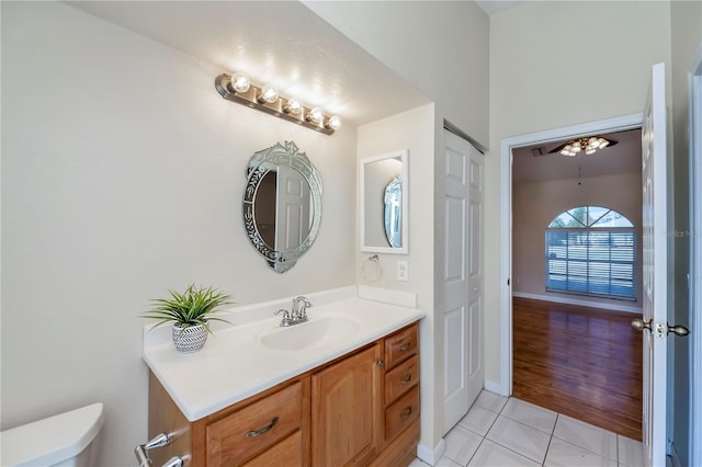 bathroom with ceiling fan, hardwood / wood-style floors, vanity, and toilet