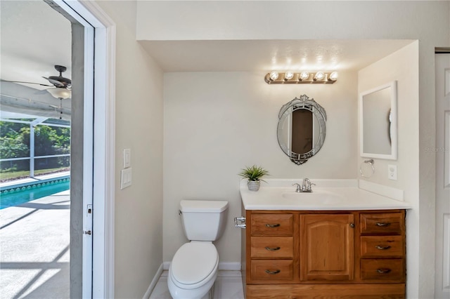 bathroom with vanity, toilet, and ceiling fan