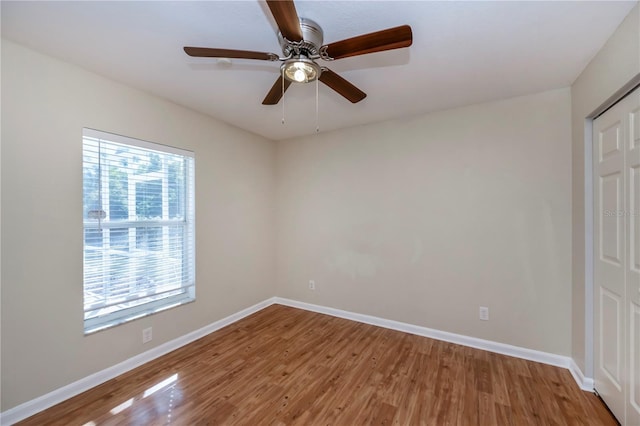 spare room with ceiling fan and wood-type flooring