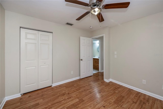 unfurnished bedroom featuring ceiling fan, wood-type flooring, and a closet