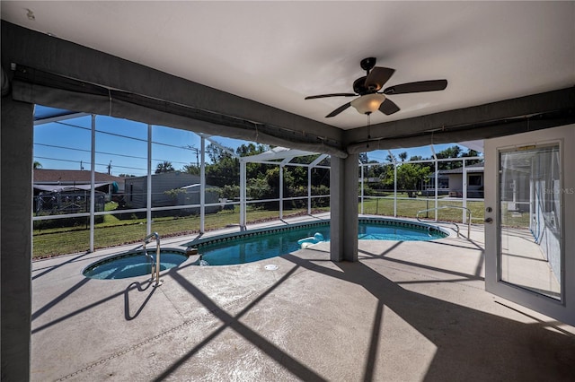 view of pool with ceiling fan, a lanai, a yard, an in ground hot tub, and a patio area