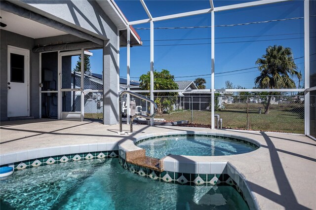 view of swimming pool with an in ground hot tub and a patio