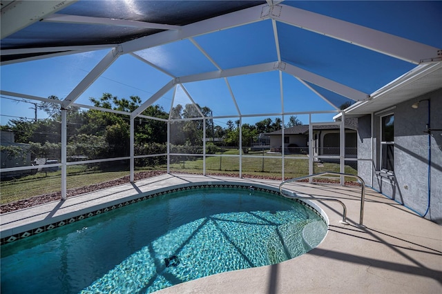 view of swimming pool with a lawn, glass enclosure, and a patio area