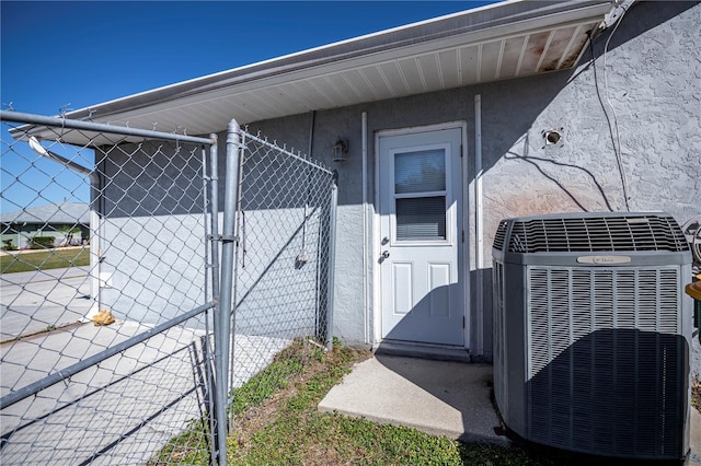 doorway to property featuring central AC unit