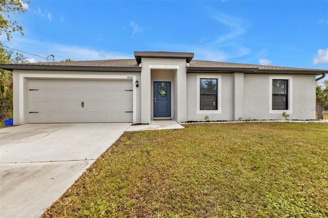 view of front of home with a front yard and a garage