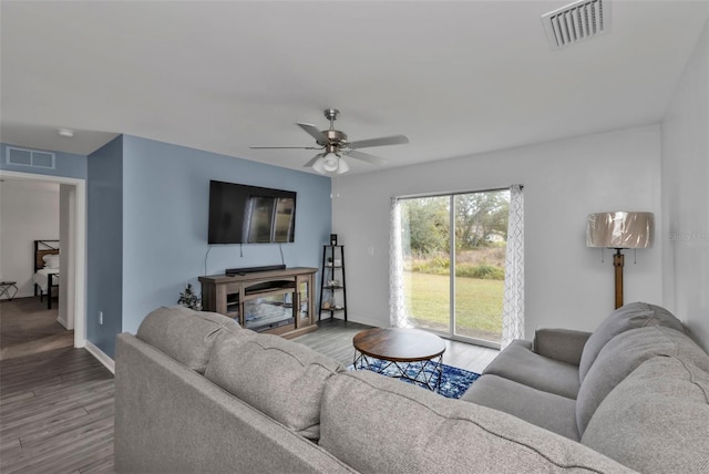 living room featuring ceiling fan and hardwood / wood-style floors