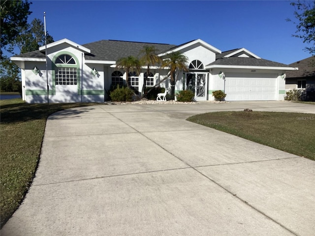 ranch-style house featuring a front lawn and a garage