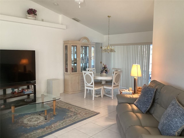 living room with light tile patterned floors, plenty of natural light, lofted ceiling, and a notable chandelier