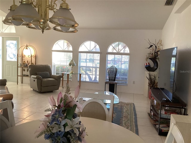 dining area with light tile patterned floors and a chandelier