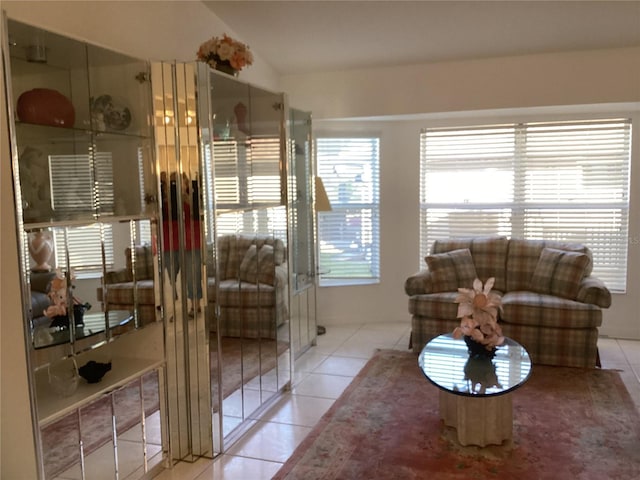 tiled living room featuring vaulted ceiling