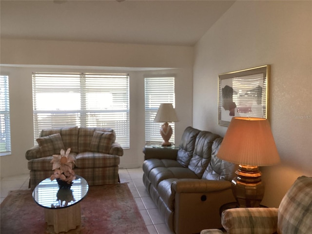 tiled living room featuring a wealth of natural light and vaulted ceiling