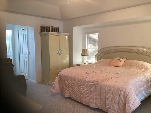 carpeted bedroom with lofted ceiling