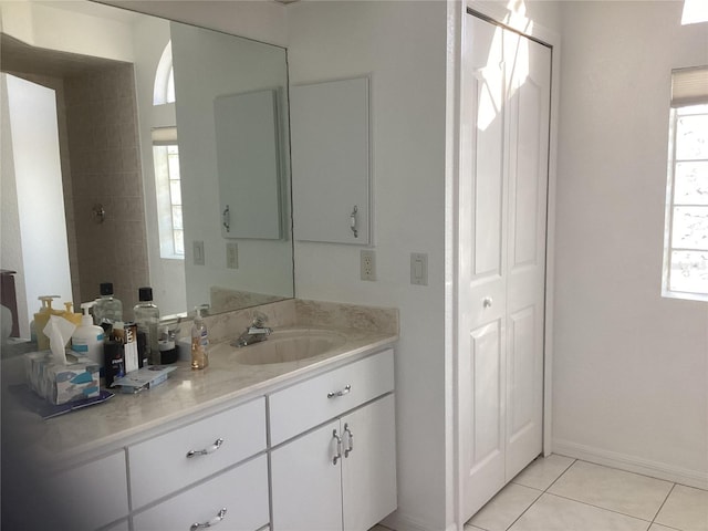 bathroom with tile patterned floors, vanity, and a wealth of natural light