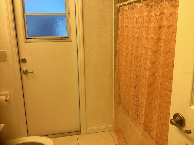 bathroom with tile patterned floors and walk in shower