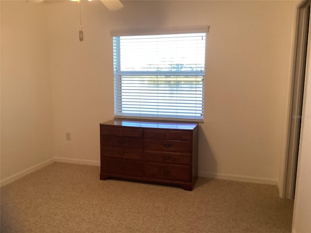 unfurnished bedroom featuring ceiling fan and light colored carpet