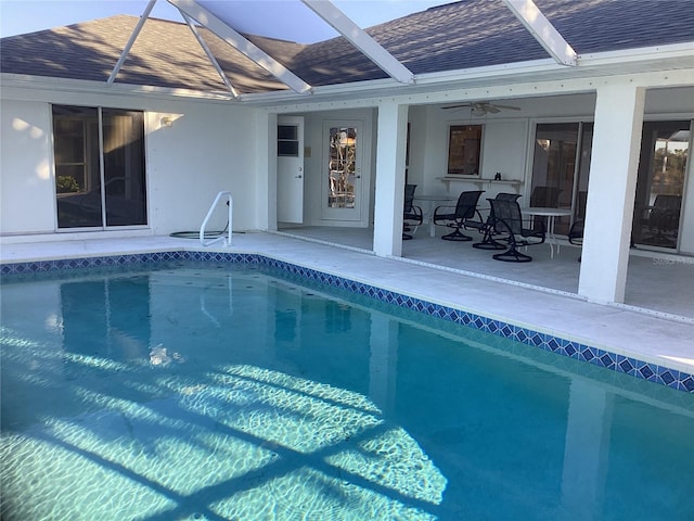 view of pool with a lanai and ceiling fan