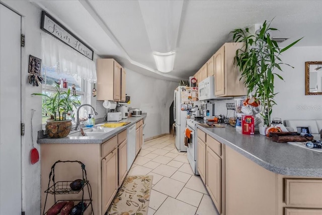 kitchen featuring light tile patterned flooring, light brown cabinets, white appliances, and sink