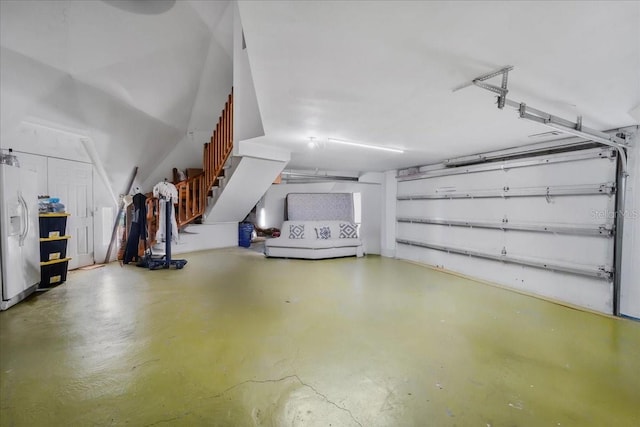 garage with white fridge with ice dispenser