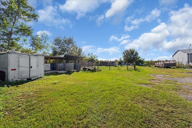 view of yard featuring a storage unit