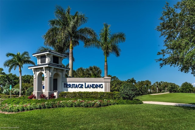 community sign featuring a lawn