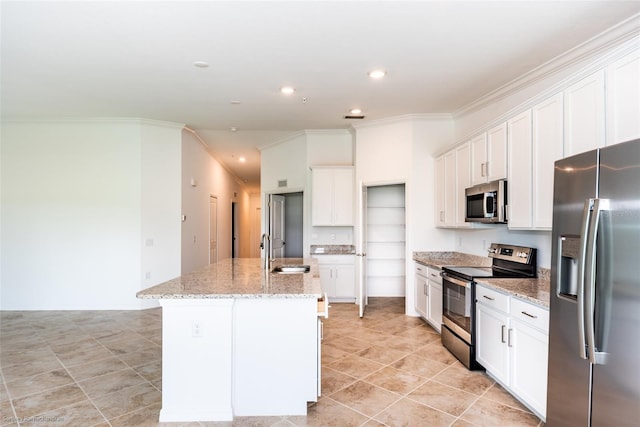 kitchen with appliances with stainless steel finishes, white cabinetry, a kitchen island with sink, and sink