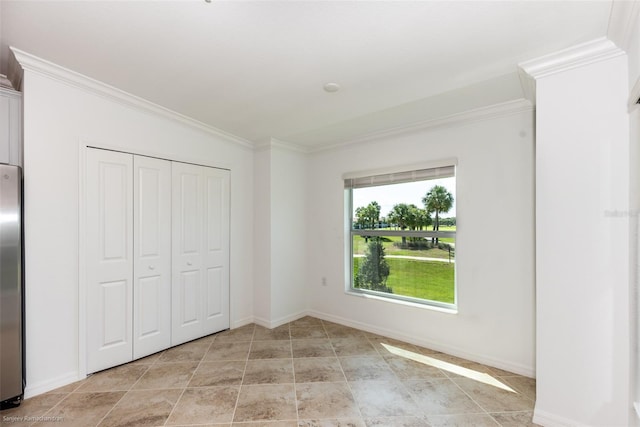 unfurnished bedroom featuring stainless steel refrigerator, a closet, and ornamental molding