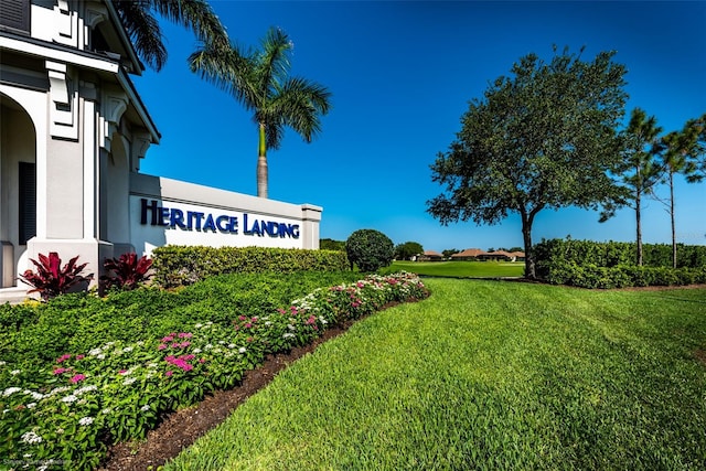 community sign featuring a lawn