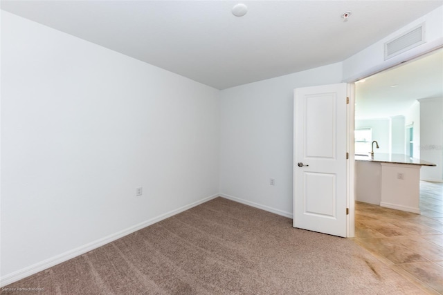 empty room with light colored carpet