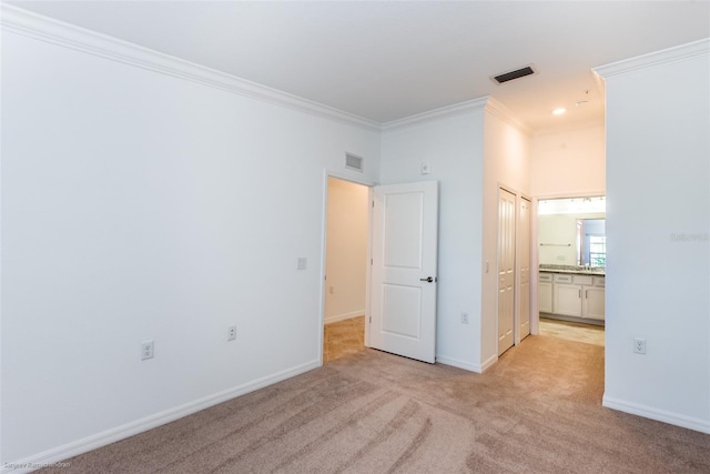 carpeted empty room featuring ornamental molding