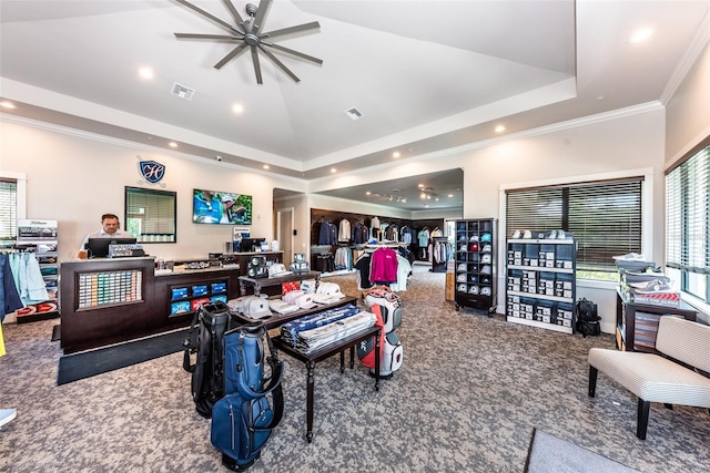 recreation room featuring a raised ceiling, ceiling fan, carpet floors, and ornamental molding