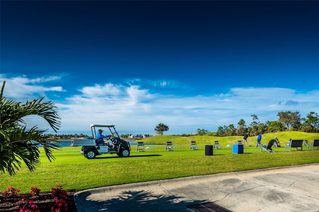 view of property's community featuring a water view and a lawn