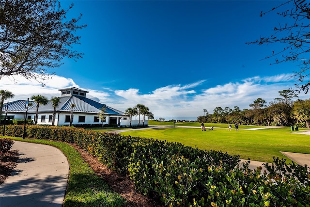 view of property's community with a lawn