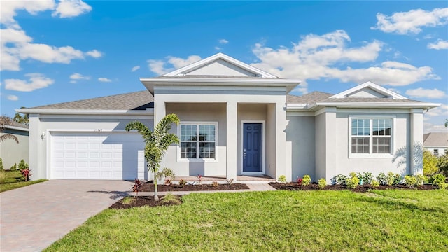 view of front facade with a garage and a front lawn