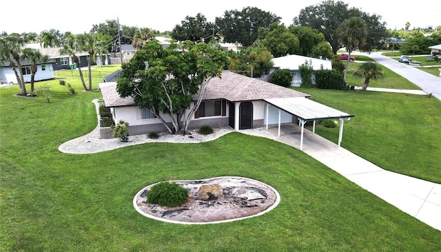 exterior space with a carport and a front yard