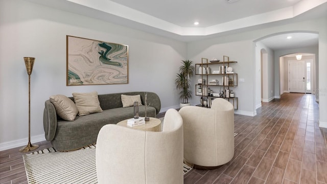 16114 Highgate St, Port Charlotte, FL 33953 - living area featuring arched walkways, dark wood-style flooring, a tray ceiling, and recessed lighting