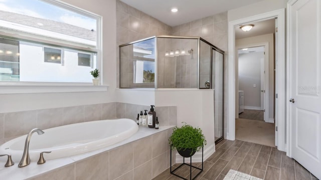 16114 Highgate St, Port Charlotte, FL 33953 - bathroom with a stall shower, a bath, and wood finished floors