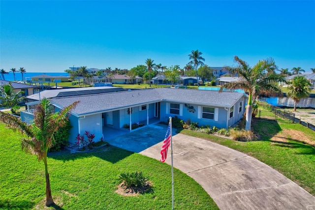 ranch-style home featuring a carport and a front yard