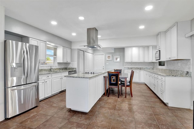 kitchen featuring a center island, light stone countertops, appliances with stainless steel finishes, white cabinetry, and island exhaust hood