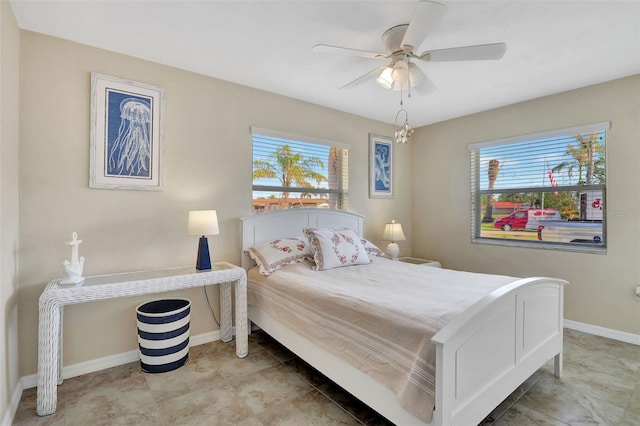 bedroom featuring multiple windows and ceiling fan