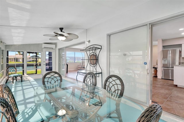 dining space with a wall mounted air conditioner, ceiling fan, and lofted ceiling