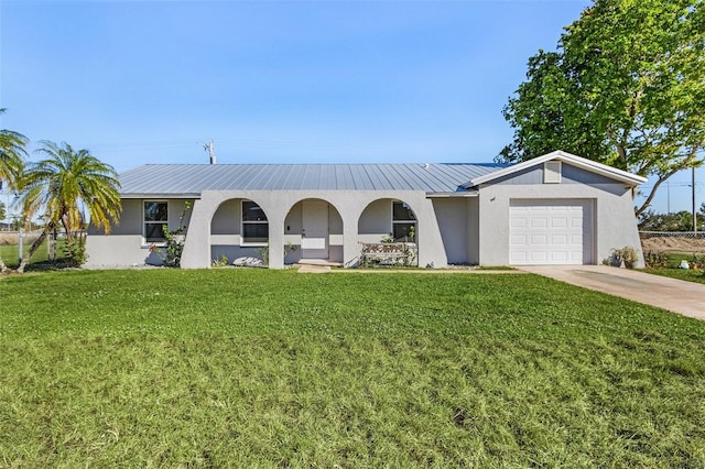 single story home with a garage and a front lawn