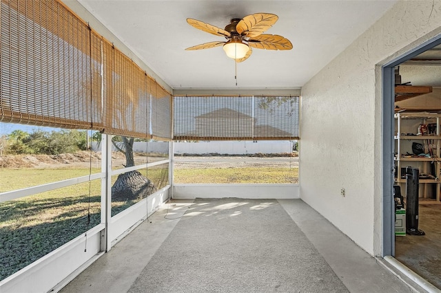 unfurnished sunroom featuring ceiling fan