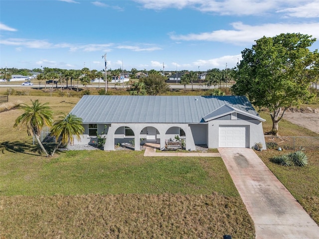 view of front of home with a front yard and a garage