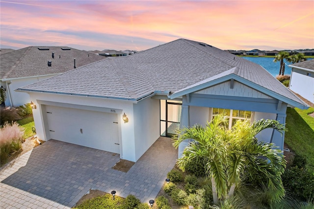 view of front of house with a water view and a garage