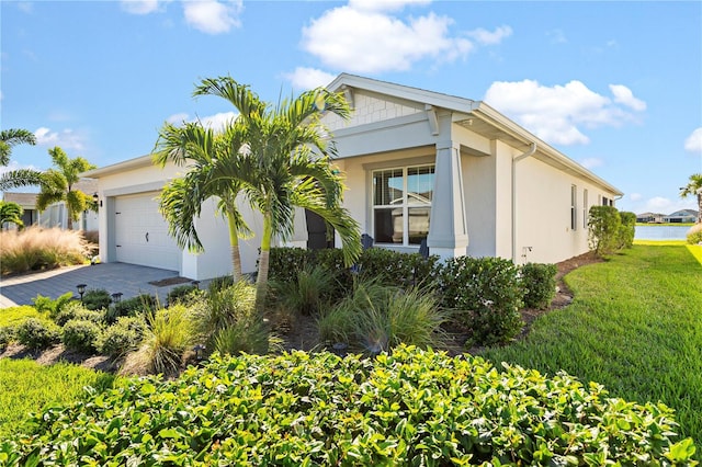 view of front of property featuring a garage and a front yard